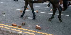 A police horse is ridden through bricks and debris thrown at police in Sunderland,England. 