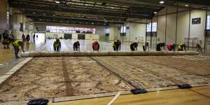 The bark cloth – Ngatu Me’a’ofa – being unfurled at Blacktown Leisure Centre on Friday. 