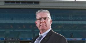 Former Glen Eira mayor Jim Magee poses at Caulfield Racecourse in 2015.