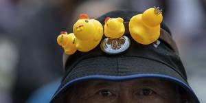 An anti-government protester wears a hat decorated with yellow ducks in Bangkok,Thailand,in 2020.