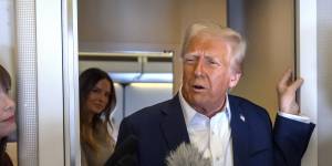 President Donald Trump speaks to reporters aboard Air Force One as he travelled from Las Vegas to Miami.