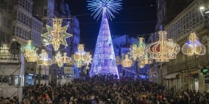 Crowds attend the lighting ceremony for Christmas decorations in Vigo,Spain.