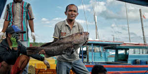 Dedi,a fisherman and resident of the Natuna Islands,with his catch.