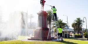 The red paint is cleaned off the Captain Cook statue in St Kilda.