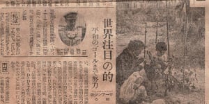 Harvey-Sutton at the microphone making his speech in the cutting from a Japanese newspaper.