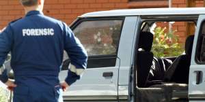 Police examine the van in which Jason Moran and Pasquale Barbaro were murdered.