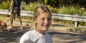 Lisa Ingram and her daughter Kira Hunter,12,pick up RATs from Angela Clarke in Bundeena.