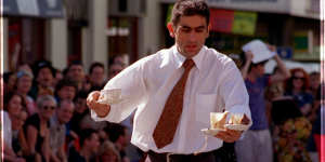 A Marios waiter spills a drop or two during the Waiters Race at Melbourne Fringe Street Parade and Party,1998.