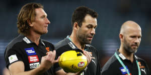 GWS assistant coaches James Hird and Dean Solomon speak with Giants interim coach Mark McVeigh.