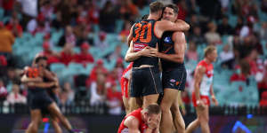 Matt Flynn and Jesse Hogan embrace after the Giants’ victory over the Swans earlier this season.