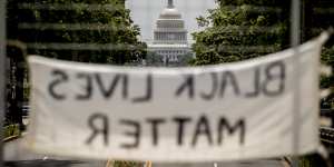 The dome of the US Capitol is visible as a sign that reads"Black Lives Matter"hangs on an overpass on North Capitol Street in Washington.