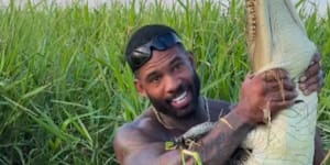 American influencer Mike Holston handling a juvenile saltwater crocodile in Far North Queensland.