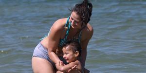 Sharlene Piggott and her two-year-old son,Jordan,getting some relief from the heat on Friday. 