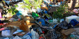 Mountains of rubbish:The home of Mary Bobolas is being cleaned out.