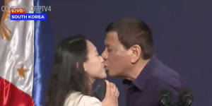 Duterte slammed for kissing married woman before huge audience