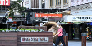  People are seen wearing face masks on the Queen Street Mall in the Brisbane CBD after Annastacia Palazczuk announced a three-day lockdown.
