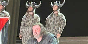 A photo posted on X showing a cast member at the Royal Opera House in London holding a Palestinian flag during a curtain call. 