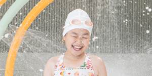 Sienna Yip,9,trials the children’s splash play area at the aquatic centre.