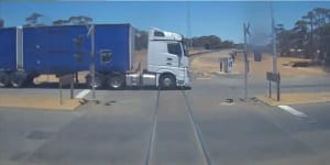 Watch the heart-stopping moment a freight train barely misses truck