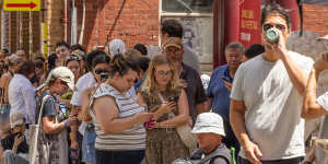 Taylor Swift fans suffered through the heat to get newly released tickets at Ticketek in Melbourne.