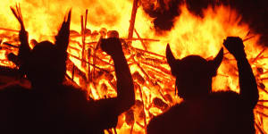 Locals dressed as Vikings are silhouetted against a burning replica Viking galley in Lerwick,Shetland,Scotland.