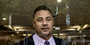 Jarryd Hayne exits the glass doors of the District Court during his trial.