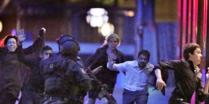 Hostages run from the Lindt Cafe towards Special Operations police on December 16,2014.