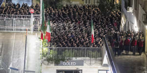 People appear to give the banned fascist salute during a rally in Rome,on Sunday to commemorate the slaying in 1978 of two members of a neo-fascist youth group in an attack later claimed by extreme-left militants.