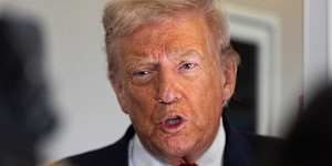 Donald Trump speaks to reporters on board Air Force One on Friday.