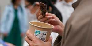 An audience member tries fried whale after watching the pro-whaling documentary Whale Restaurant:Inconvenient Food at Waseda University in Tokyo.