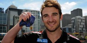 Essendon skipper Jobe Watson holds the Brownlow,which was later taken from him.