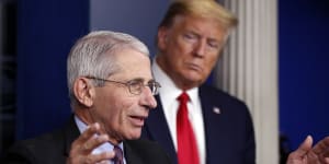 Then-president Donald Trump watches as Fauci speaks at a coronavirus press conference in April 2020. 