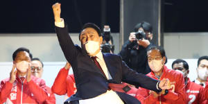 Newly elected president Yoon Suk-yeol celebrates with supporters in Seoul.