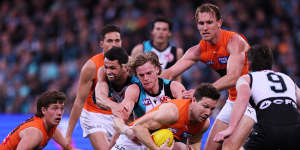 Port Adelaide’s Miles Bergman attempts to tackle Giants star Toby Greene amid the crush on Sunday.