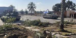 A tank with an Israel flag on it entering the Gaza side of the Rafah border crossing on Tuesday.