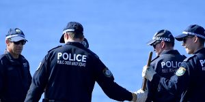Police undertake a search at North Head near Manly.