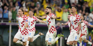 Croatia players react at the end of the World Cup quarterfinal soccer match.