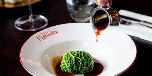 Foie gras-stuffed cabbage ballotine with veal demi-glace.