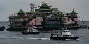 Tugboats tow the Chinese imperial-style Jumbo Floating Restaurant out of a typhoon shelter in Aberdeen on June 14,2022 in Hong Kong,China. 