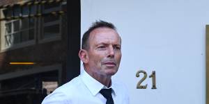 Former prime minister Tony Abbott leaves Beppi’s restaurant in Darlinghurst after the funeral. 
