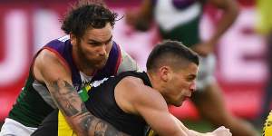 Dion Prestia handpasses under pressure from Nathan Wilson.