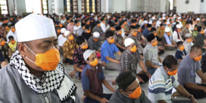 Muslim men wearing face masks perform Friday prayer at the distance of about one meter (3 ft) to each other as a social distancing effort to prevent the spread of new coronavirus outbreak at Al Akbar mosque in Surabaya,East Java,Indonesia,Friday,March 20,2020. The vast majority of people recover from the new coronavirus. According to the World Health Organization,most people recover in about two to six weeks,depending on the severity of the illness.