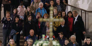 People queue to walk past the coffin of Queen Elizabeth II as it lies in state on the catafalque in Westminster Hall.