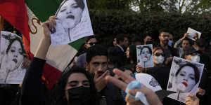 Demonstrators hold placards outside the Iranian Embassy in London,Sunday.