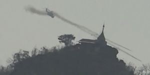 A Myanmar military helicopter fires rockets west of Loikaw in Kayah state on February 21,an image provided by Free Burma Rangers. 