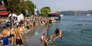 People cool off by the Bosphorus to escape hot weather in Istanbul,Turkey on July 14.