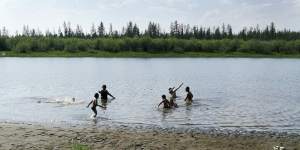 Children play in the Krugloe Lake outside the Arctic town of Verkhoyansk,about 4660 kilometres north of Moscow where the temperature hit 38 degrees this week.