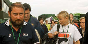 Australia’s Jelena Dokic walks through Wimbledon with her father,Damir.