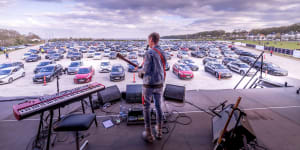 Danish musician Mads Langer performs to an audience in socially distanced cars.