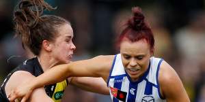 Jenna Bruton Kangaroos is tackled by Richmond opponent Gabrielle Seymour during their clash at Arden Street.